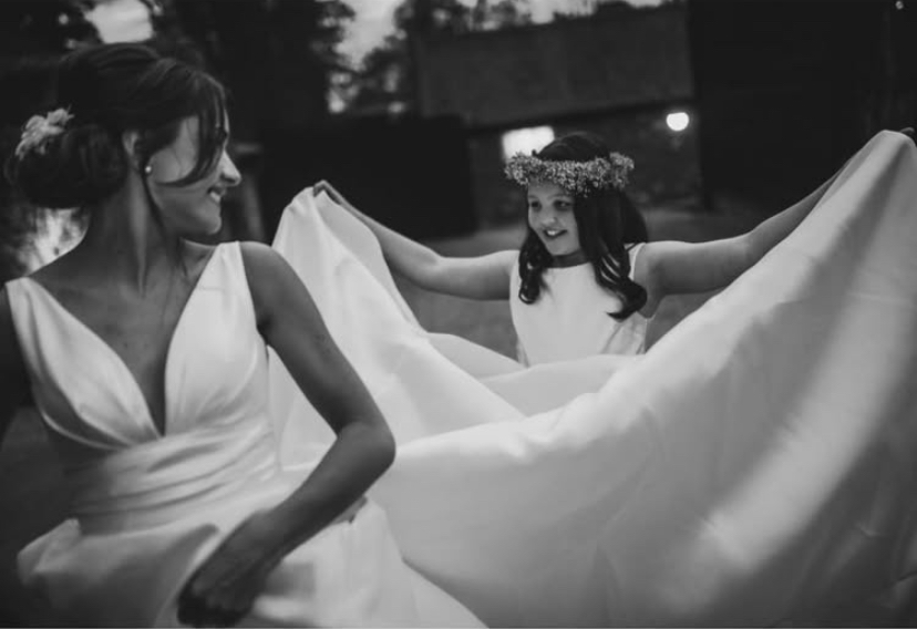 A bride and flower girl celebrating together