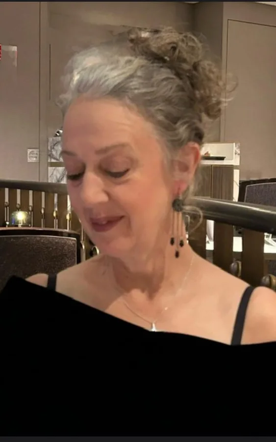 Lynn reading and preparing words for a ceremony