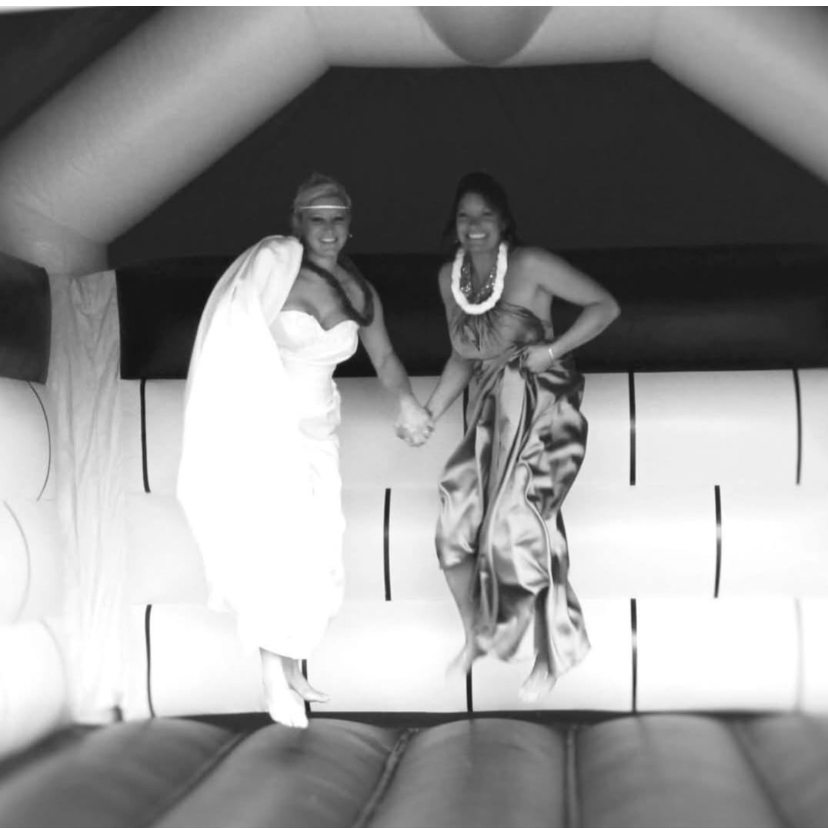 A bride and bridesmaid laughing together