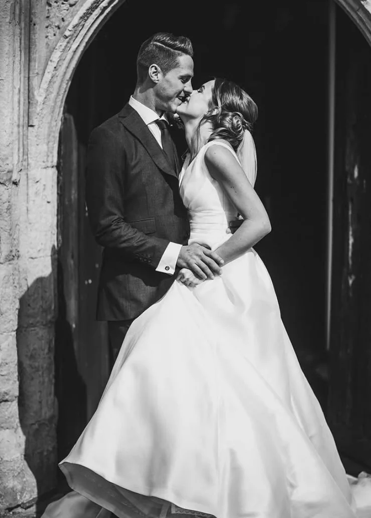 A couple in wedding dress embracing